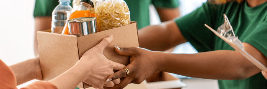 Hands passing a box of food